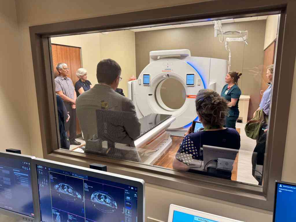 Group of people standing next to the new CT scan machine at UAB St. Vincent's Birmingham Bruno Cancer Center