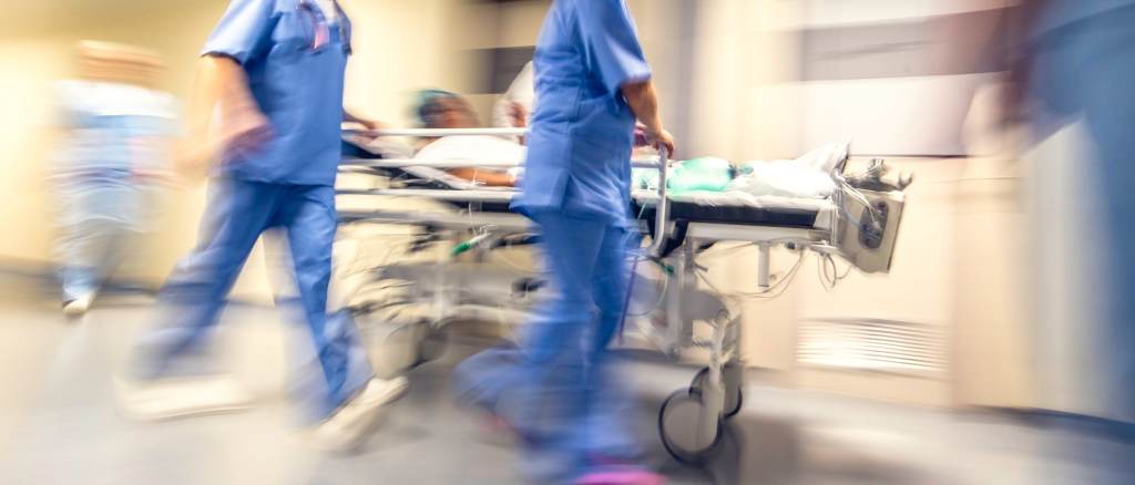 Emergency medical team rushes a patient on a stretcher through a hospital hallway, representing rapid trauma response and coordinated care in the UAB eMedicine teletrauma program connecting UAB St. Vincent’s patients to specialized care in Alabama.