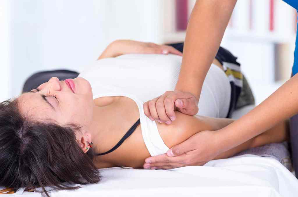 Woman receiving treatment for a dislocated shoulder injury