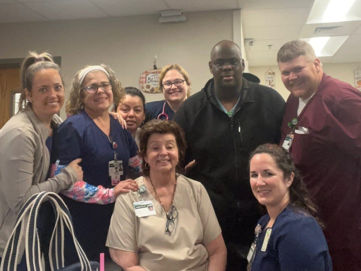 Robin Wadsworth sitting with her team at UAB St. Vincent's Birmingham