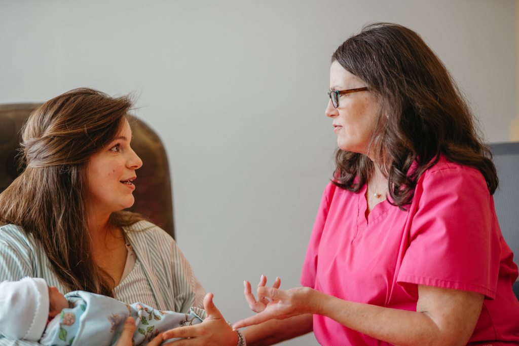 New mother and her baby receiving a consultation from a UAB St. Vincent's lactation consultant.