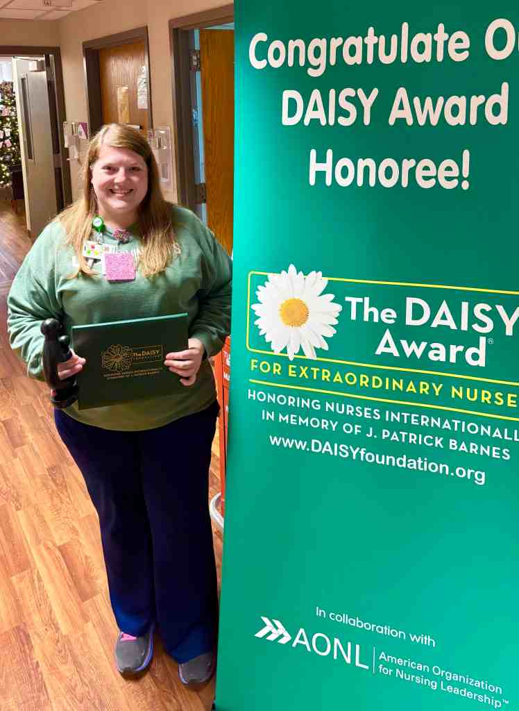 Heather Walker, Rn stands in UAB St. Vincent's East holding her DAISY Award.