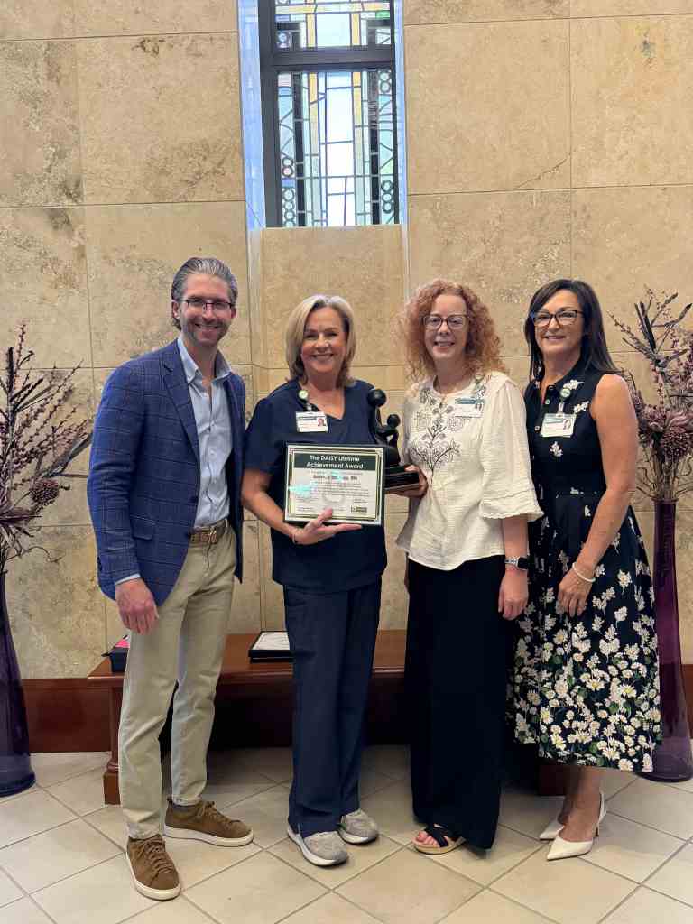 Belinda Thomas and leadership stand in UAB St. Vincent's Birmingham at the nursing award ceremony
