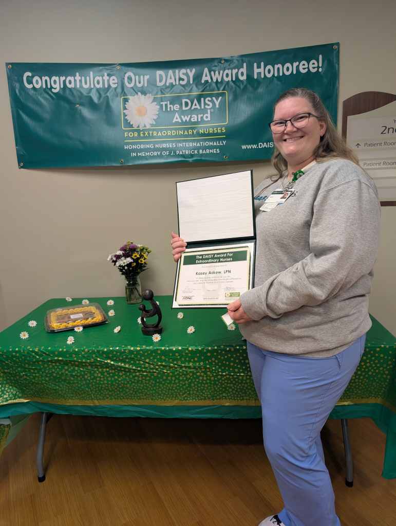 Kasey Askew, LPN stands with her DAISY Award at UAB St. Vincent's St. Clair