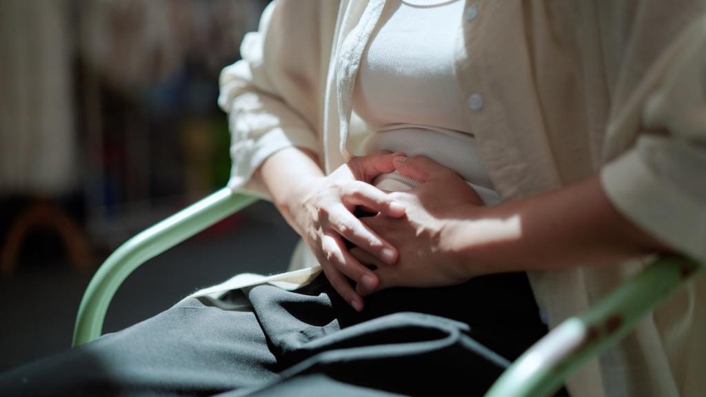 Woman clenching stomach in pain