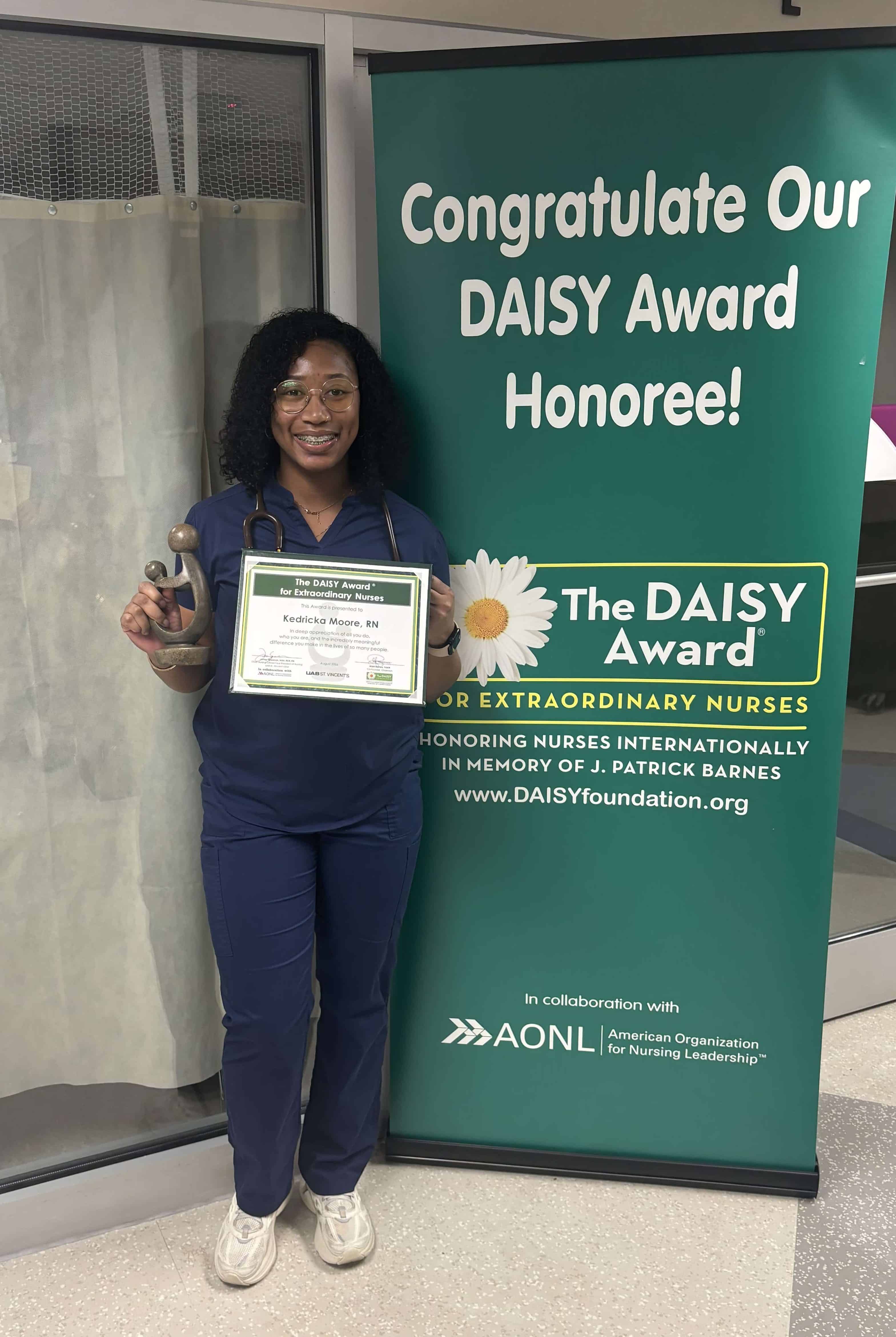 Kedricka Moore, RN standing with her DAISY Award
