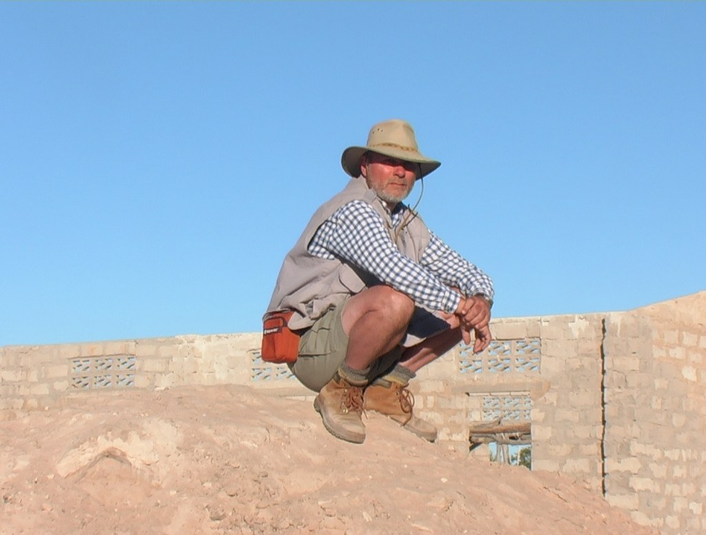 Ronnie Hubbard sitting on a mound in Africa